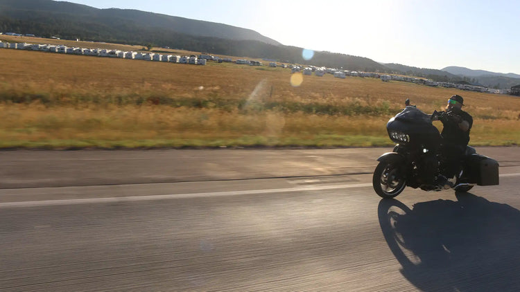 Motorcyclist riding on a deserted road.