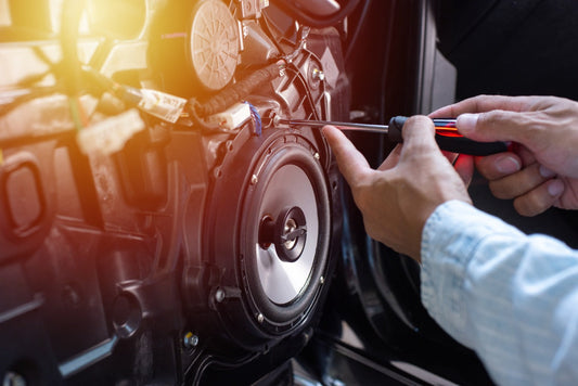 A technician works on a car audio amplifier.